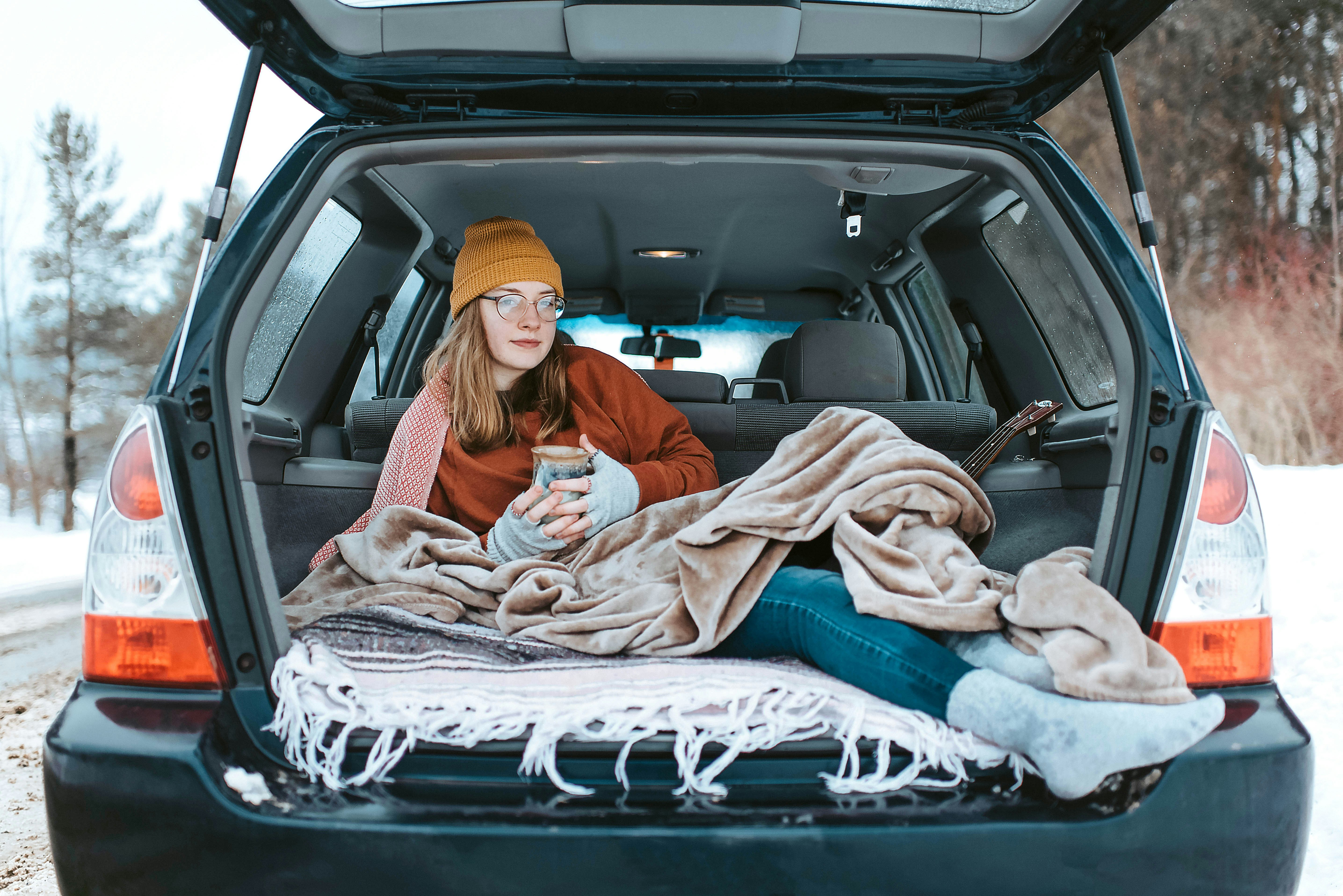 woman lying down on car compartment